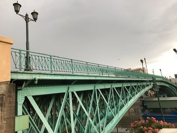 Low angle view of footbridge against sky