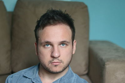 Portrait of young man at home