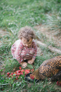 Portrait of cute girl picking fruit on field