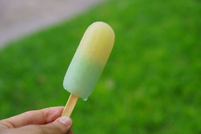 Close-up of hand holding ice cream