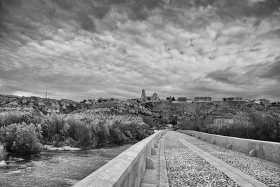 View of railroad tracks against cloudy sky