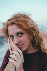 Cropped hand of person touching young woman 