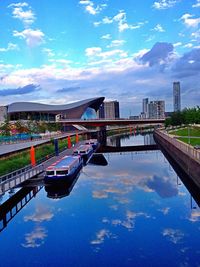 Bridge over river against cloudy sky