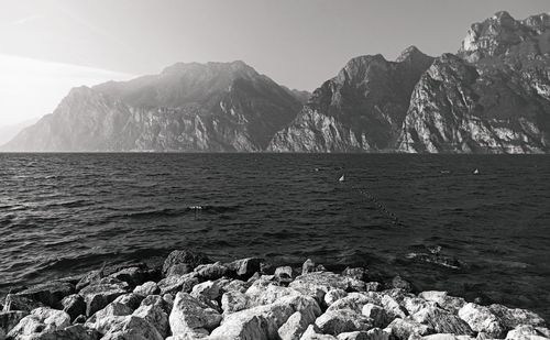 Scenic view of sea and mountains against sky