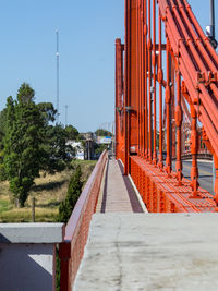 View of empty footpath against clear sky