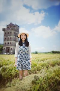 Portrait of woman standing on field