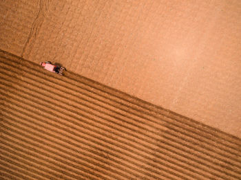 Aerial view of tractor working in agricultural field