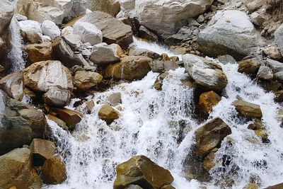 High angle view of river flowing through rocks