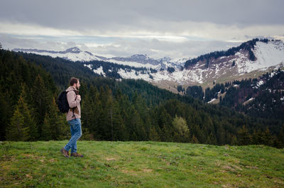 Full length of man standing on mountain against sky