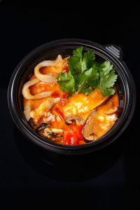 High angle view of food in bowl against black background