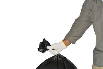 Close-up of hand holding umbrella against white background