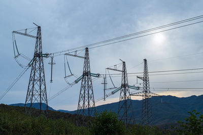 Low angle view of electricity pylon against sky