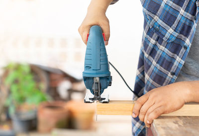 Close up the carpenter cutting wooden stick bar on the table for d.i.y craft.