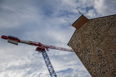 Low angle view of crane against sky