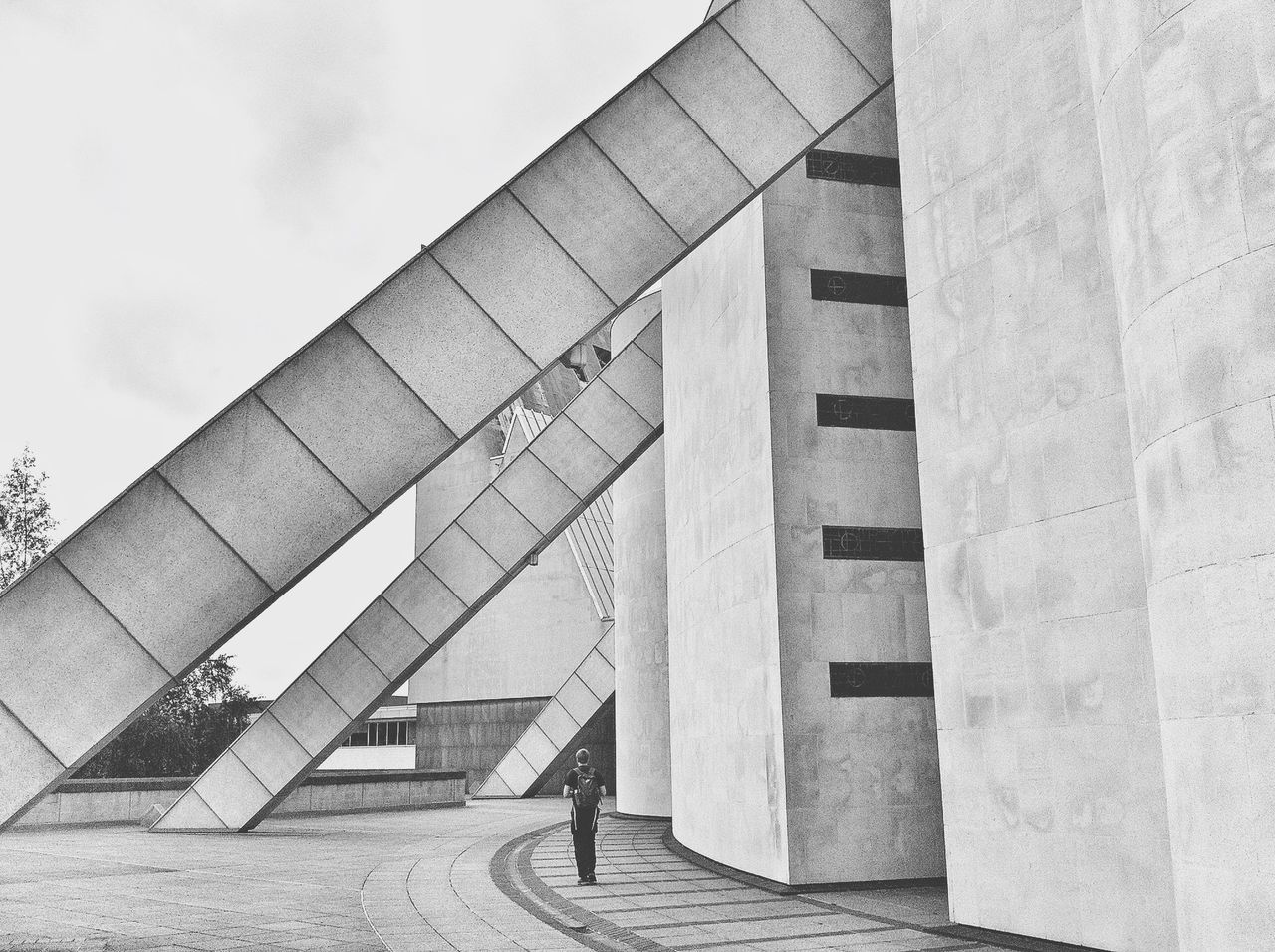 architecture, built structure, building exterior, sky, lifestyles, men, shadow, walking, sunlight, leisure activity, day, unrecognizable person, footpath, outdoors, person, wall - building feature, street, the way forward