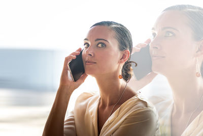 Portrait of young woman using mobile phone