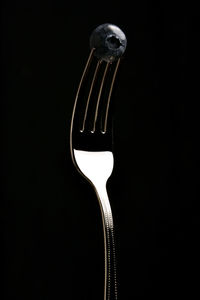 Close-up of fork over black background