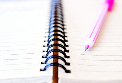 Extreme close-up of pen on spiral notebook