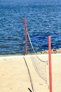 Red flag on beach against sea