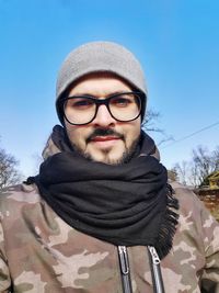 Portrait of man wearing hat against sky during winter