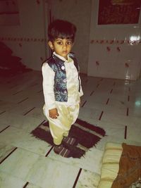 Portrait of cute girl standing at home