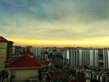 High angle view of buildings against sky during sunset