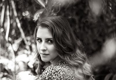 Portrait of beautiful woman with long hair standing outdoors