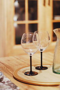 Close-up of wine glasses on table