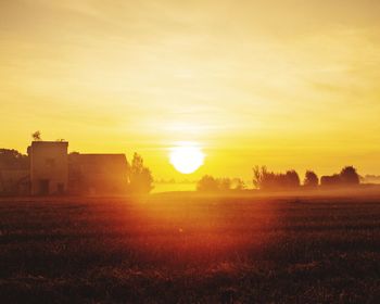 Scenic view of field against sky during sunset