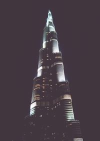 Low angle view of modern building against sky at night