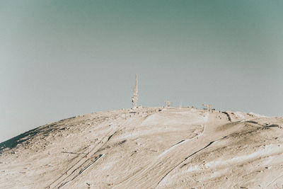 Low angle view of communications tower against sky