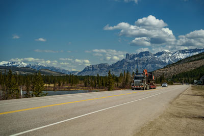 People walking on road against sky