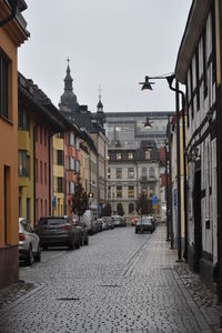 Street amidst buildings in city against clear sky