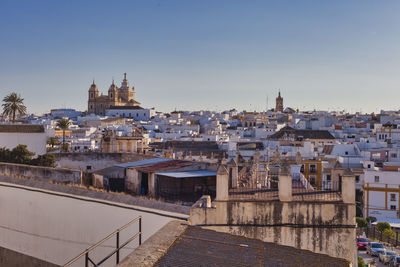 View of buildings in city against clear sky