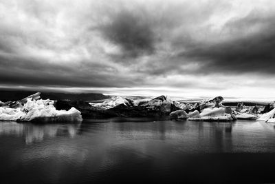 Scenic view of lake against sky during winter