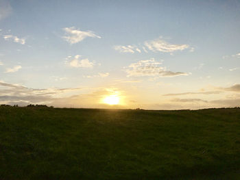 Scenic view of field against sky during sunset