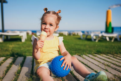 Portrait of cute girl eating food at park