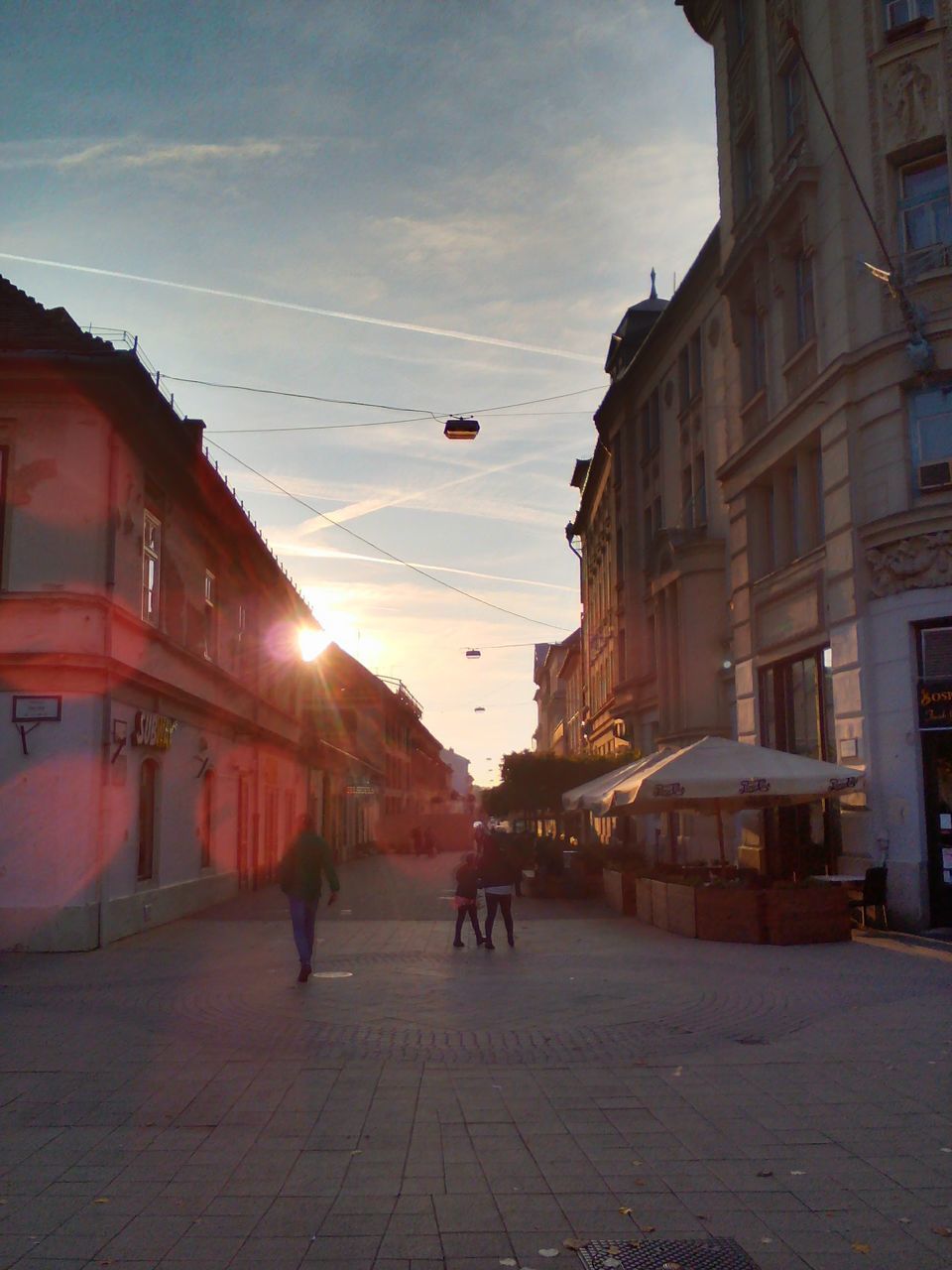 PEOPLE WALKING ON ROAD IN CITY