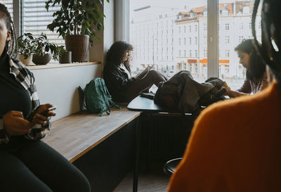 Female friends sitting in university cafeteria