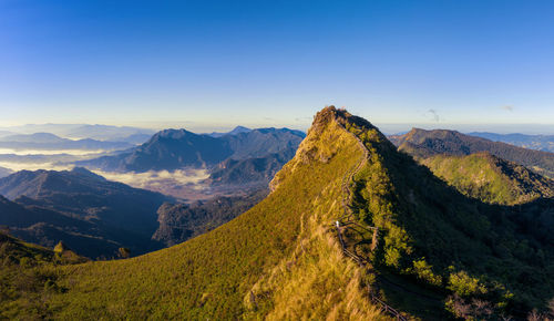 Scenic view of mountains against clear blue sky