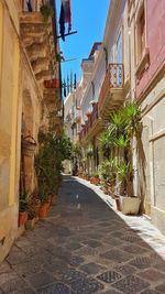 Street amidst buildings against sky