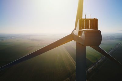 Aerial view of close up windmill turbine in countryside area, wind power and renewable energy