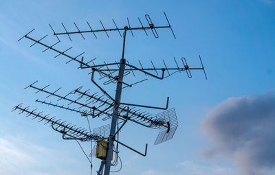 Low angle view of communications tower against sky