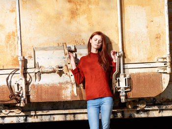 Portrait of young woman standing in factory