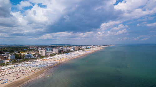 Aerial view of sea and buildings against sky