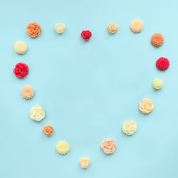 High angle view of heart shape on table against blue background