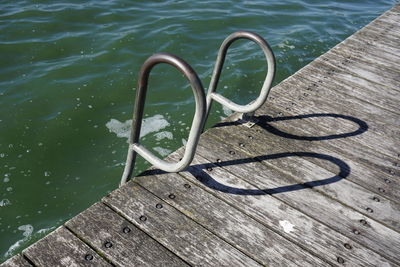 High angle view of metal railing by swimming pool