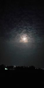 Low angle view of illuminated moon against sky at night