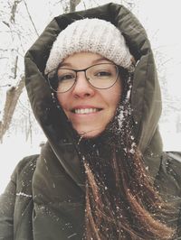 Close-up portrait of smiling young woman during winter
