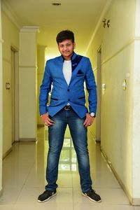 Full length of young man standing in corridor